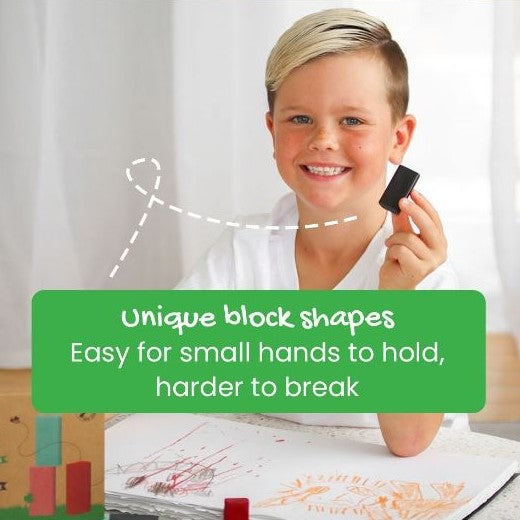 Young boy holding a black rectangle block crayon.