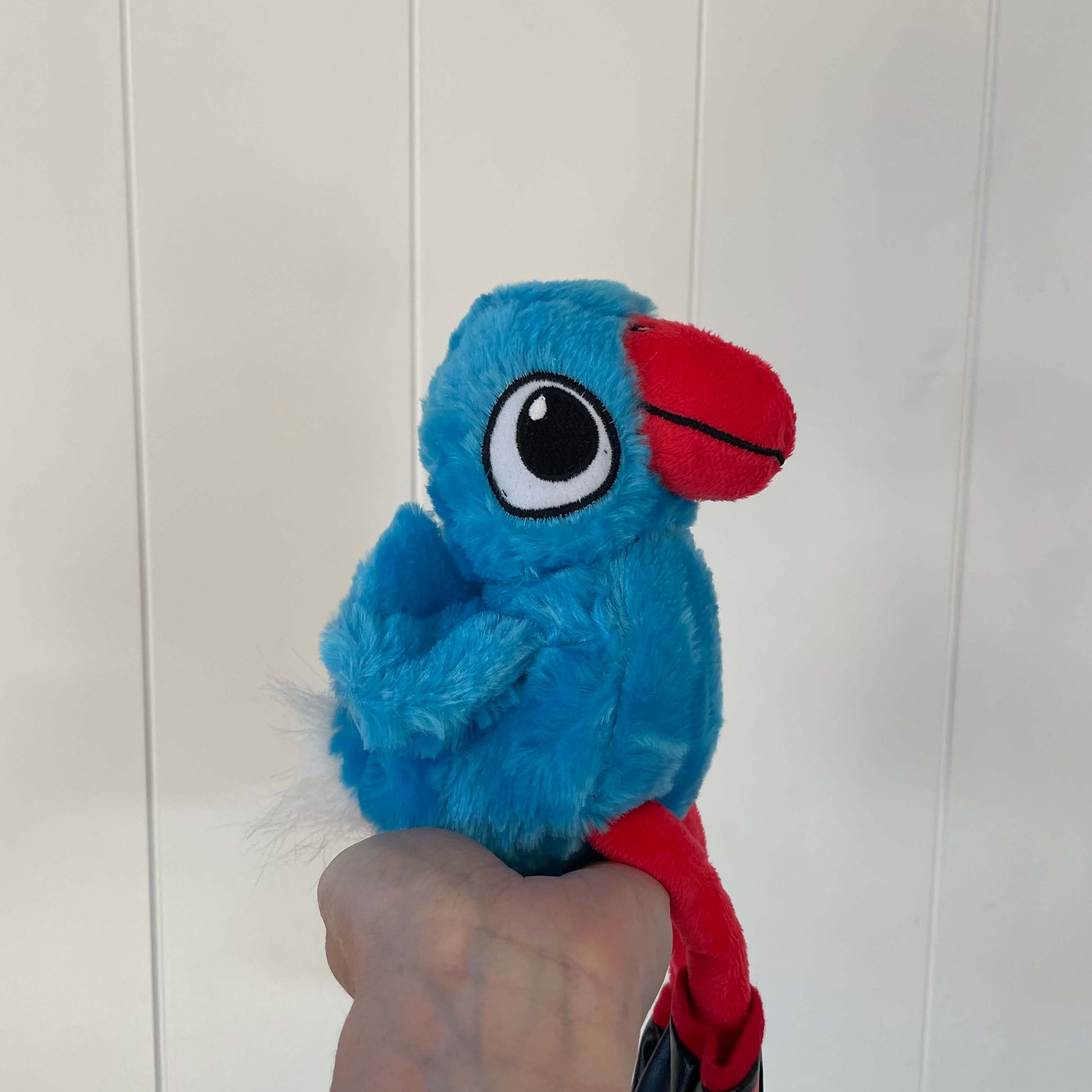 Plush pukeko toy sitting in the palm of a womens hand..