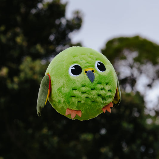 Inflatable plush Kea bird ball in mid air.