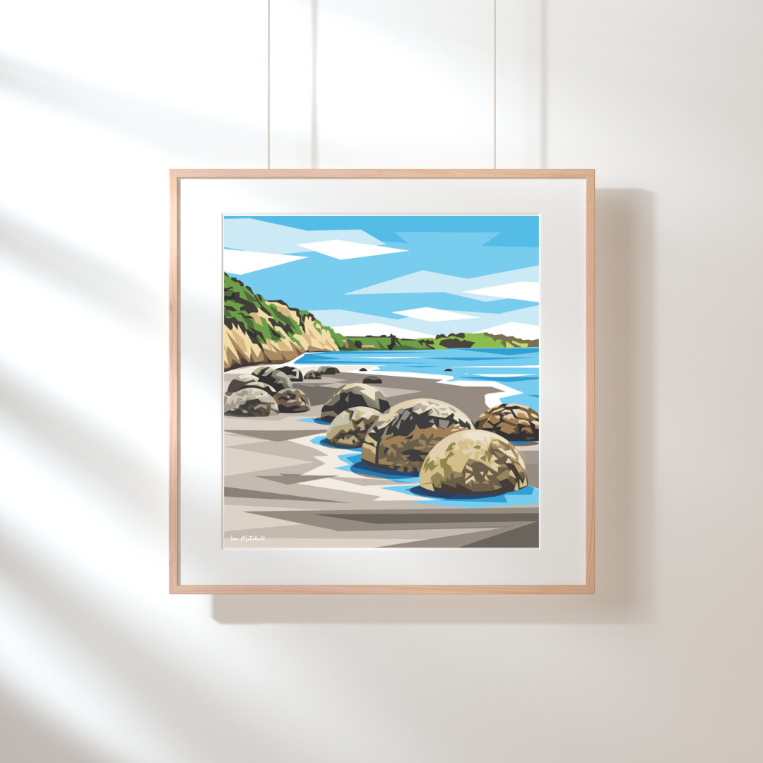 Art print by Ira Mitchell. Geometric style image featuring the boulders on the beach at Moeraki in New Zealand. Hanging against a white wall in a light wooden frame with white border.