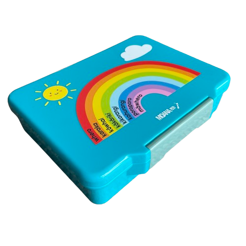 Bright blue kids lunch box with rainbow decal and te reo maori written in black in each colour section of the rainbow.