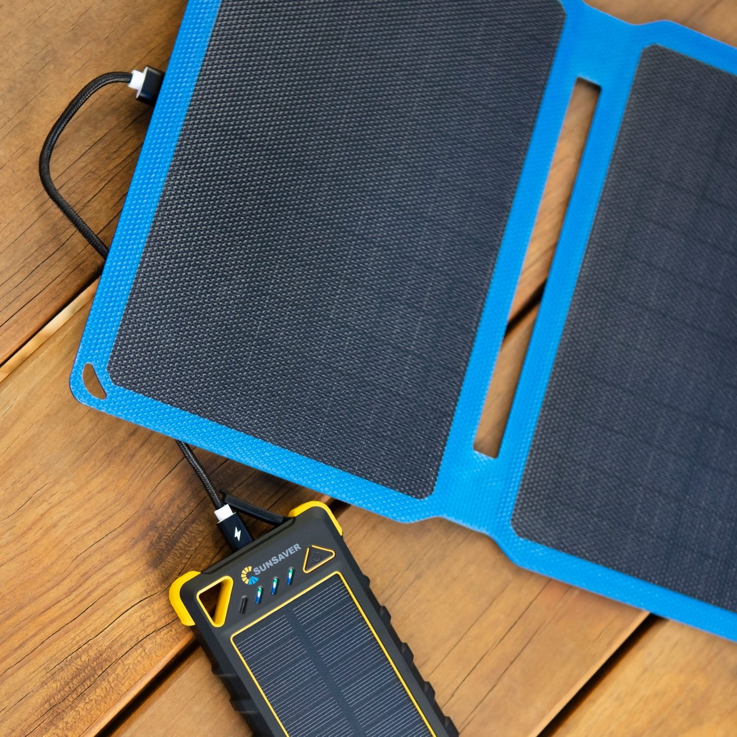 SunSaver portable solar panel charging a portable battery pack.