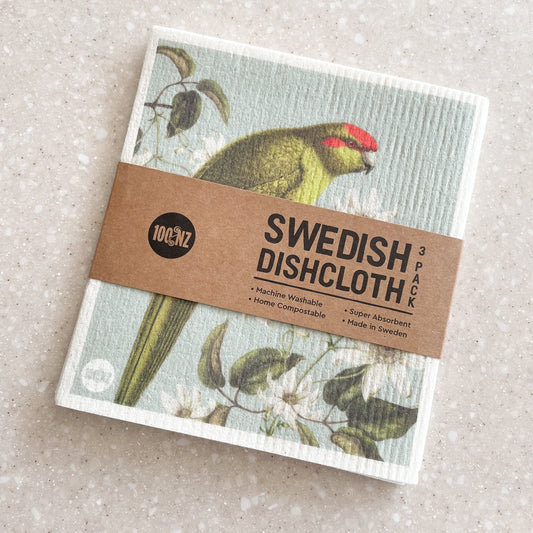 Swedish Dishcloth 3 pack showing the top one with a Kakariki bird sitting amongst white flowers.