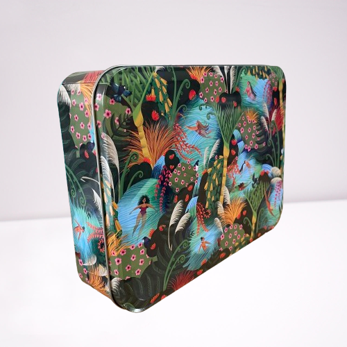 Beautiful rectangle tin sitting on it's side depicting artwork called Wahine in Water. A bright river and forest scene with native NZ birds and trees and women swimming.