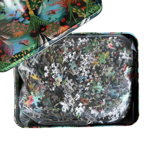 Beautiful rectangle tin sitting opened up containing a jigsaw puzzle depicting artwork called Wahine in Water. A bright river and forest scene with native NZ birds and trees and women swimming.