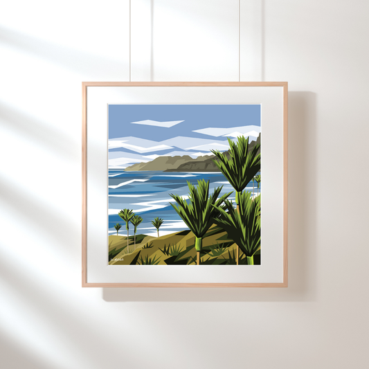 Art print by Ira Mitchell. In a geometric style, this print depicts a New Zealand West Coast with 7 Nikau plam trees on the foreshore. Hanging on a white wall in a light wooden frame and white border.