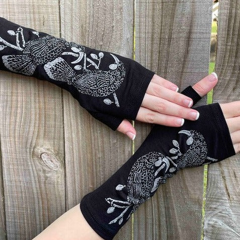 Fingerless merino gloves in black with grey Huia bird print.