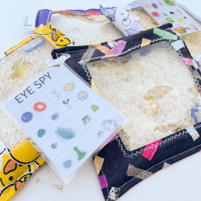 Childrens Eye Spy sensory discovery bags with clear plastic window and filled with rice and mystery objects to find.