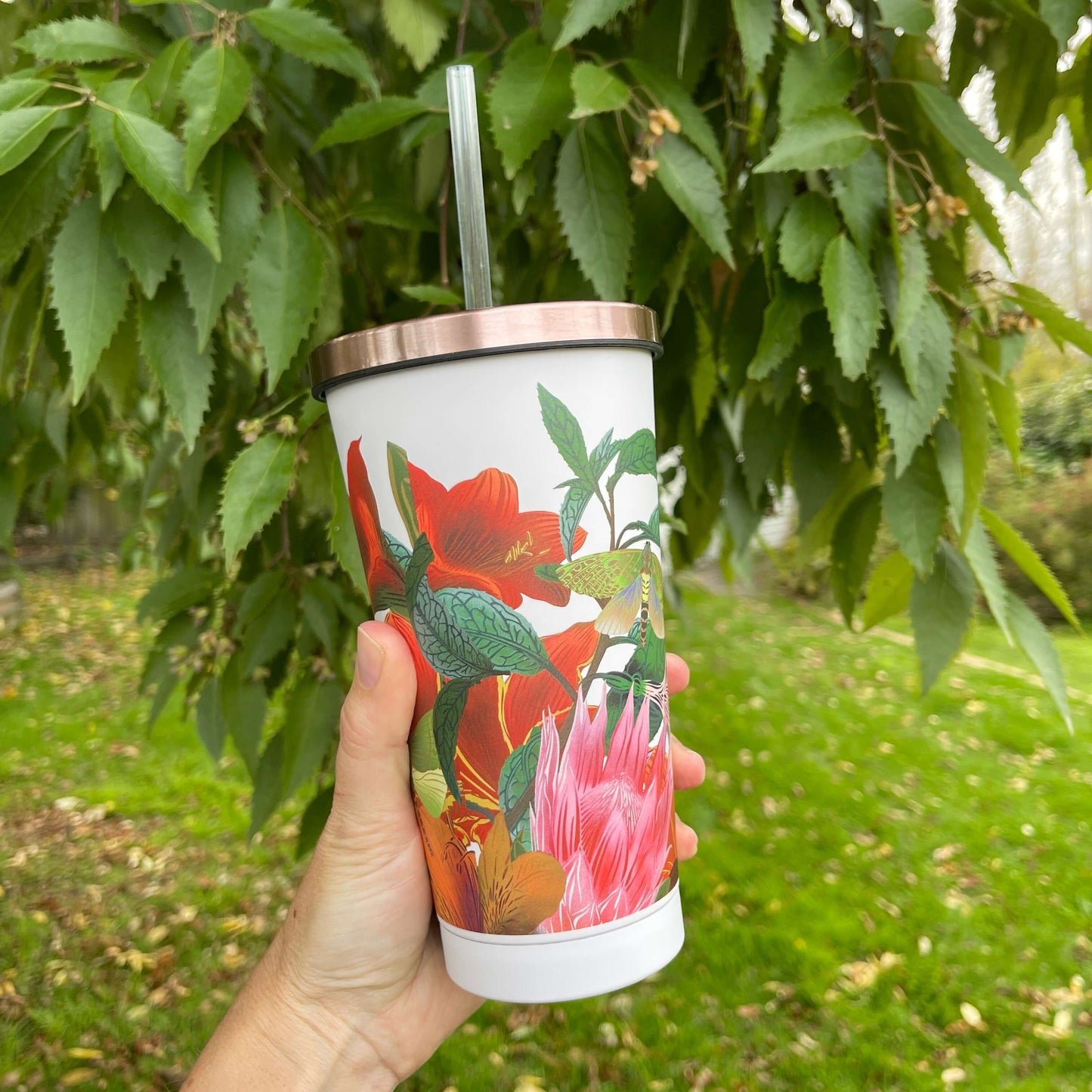 Stainless steel smoothie cup with rose gold lid and straw. Featuring a floral design by artist Flox. 