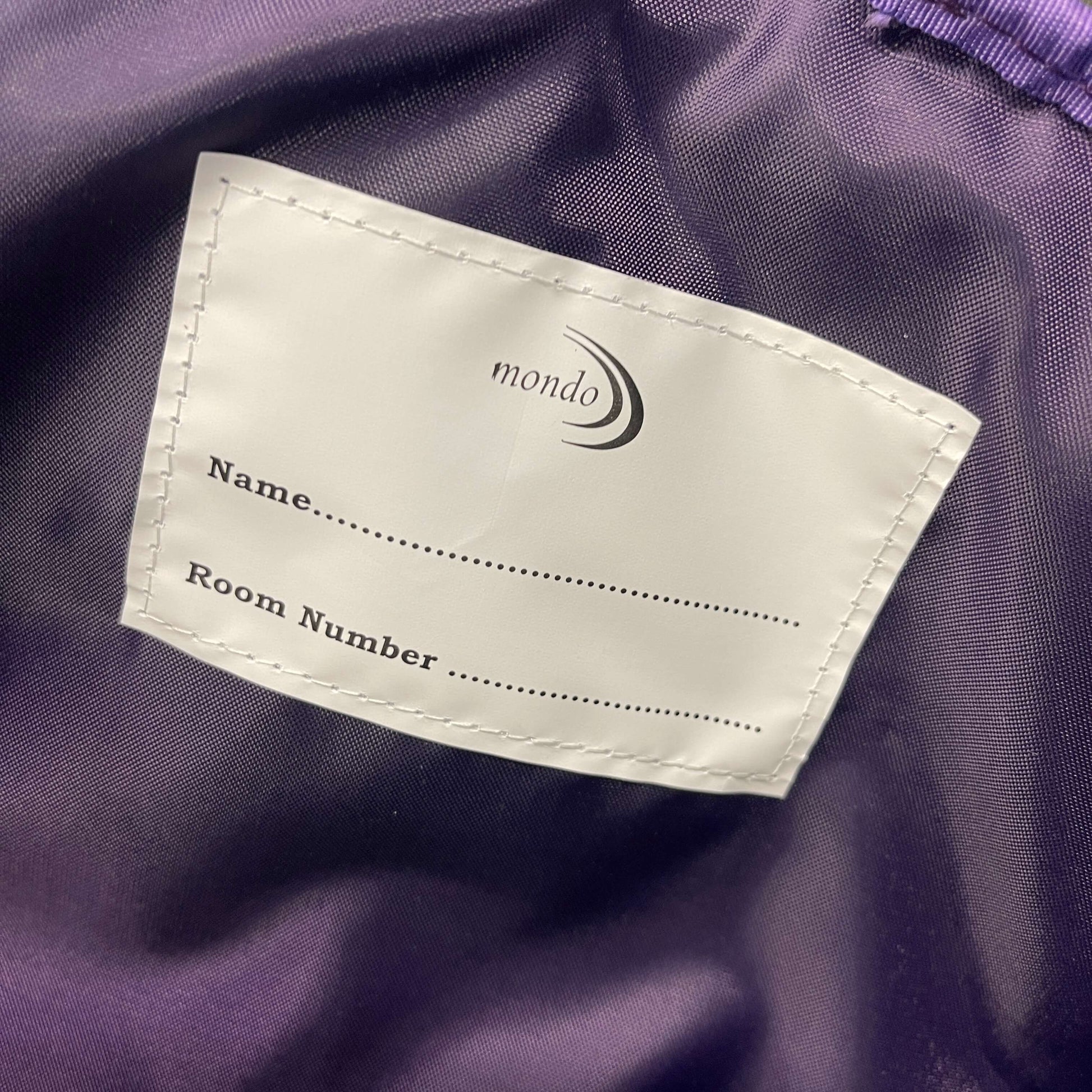 Name and room label inside childs school backpack.